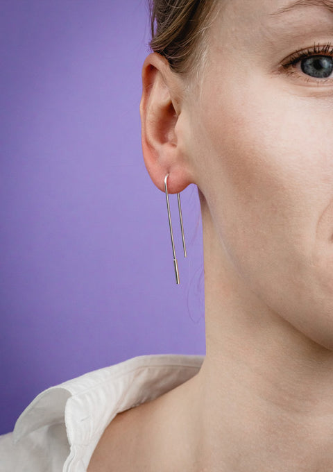 2. Close-up of women's U-shaped silver earrings by Maarja Palu, highlighting sleek design