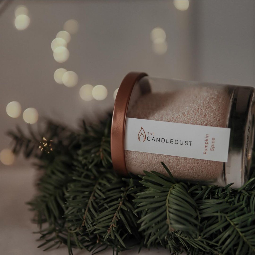 6. Candledust Pumpkin Spice powdered candle on a bed of pine branches, holiday setting