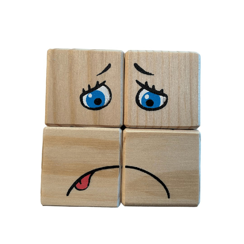 4. Four pinewood blocks depicting a worried face with blue eyes and a tongue out, from ROOSI Traditional Toys' Special Expressions Blocks for Kids