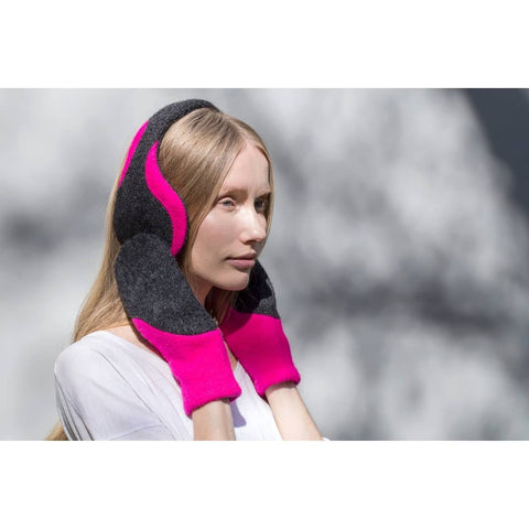 1. Woman wearing HERTTA neon pink and dark grey felted wool mittens outdoors