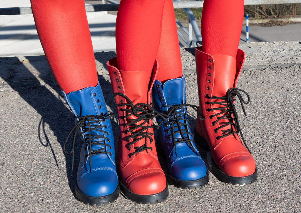 1. Close-up of two pairs of boots, one blue and one red, worn with red leggings outdoors
