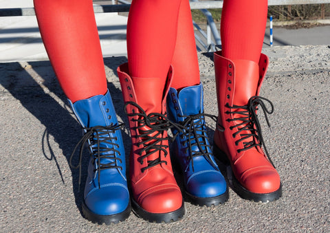 1. Close-up of two pairs of boots, one blue and one red, worn with red leggings outdoors