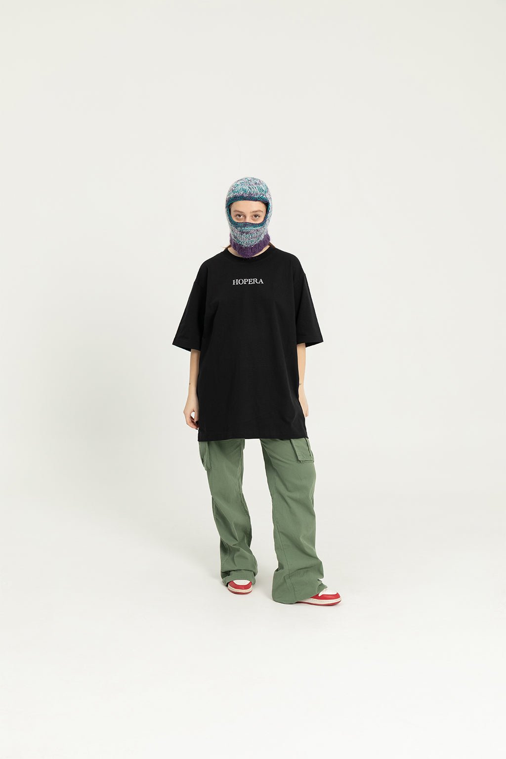 6. Front view of female model in black Hopera T-shirt, studio setting