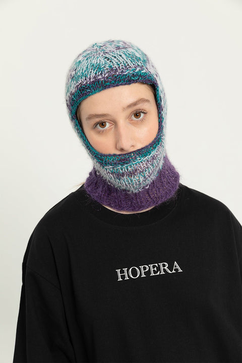 5. Full view of female model wearing black Hopera T-shirt with 'Dans les Vagues' artwork, studio setting