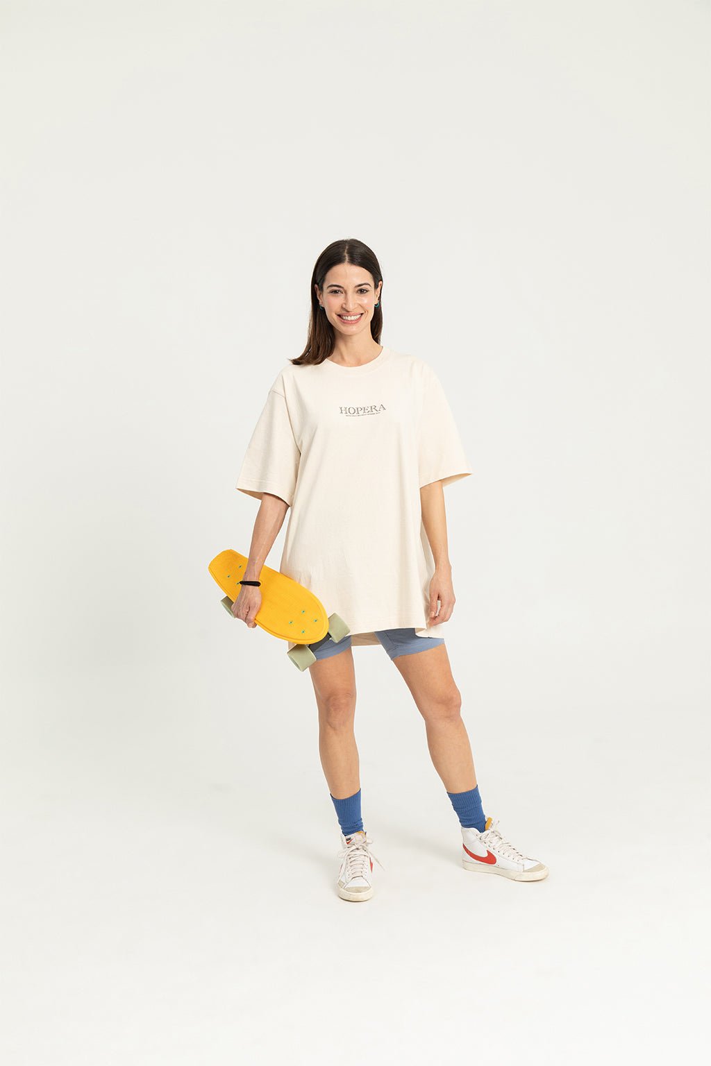 7. Women's 'Bijutsu Sekai' t-shirt by Watanabe Seitei, front view, worn by female model with skateboard, lifestyle setting