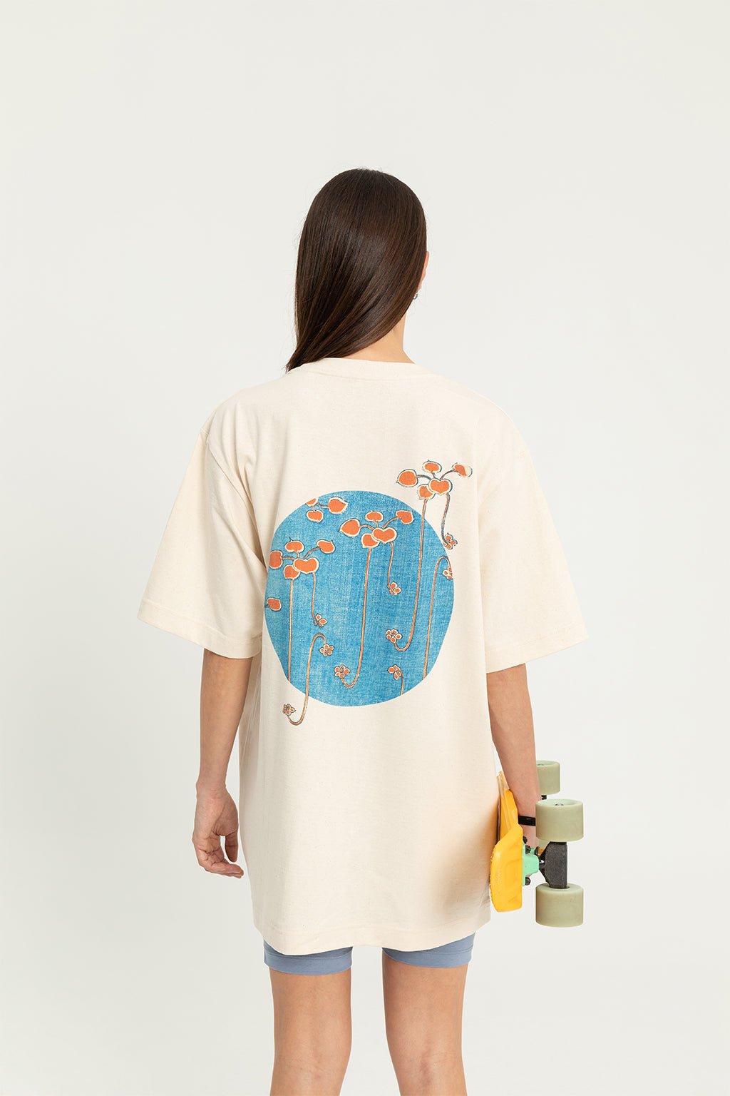 6. Women's 'Bijutsu Sekai' t-shirt by Watanabe Seitei, worn by female model with skateboard, showing back design, lifestyle setting