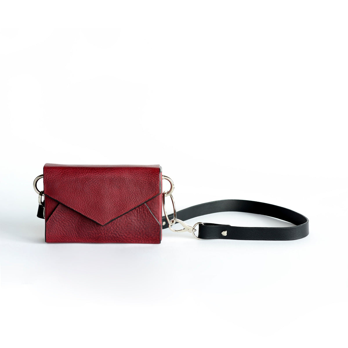 5. Flat lay of Daz Studio burgundy leather envelope bag with adjustable strap and silver magnet closure