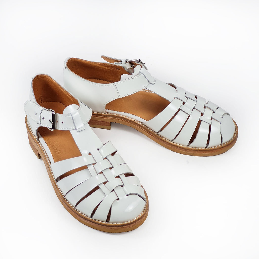 6. Side view of Daz Studio's white leather fisherman sandals, highlighting round toe and leather sole