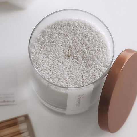 2. Top view of Candledust powdered candle in glass with open rose gold lid