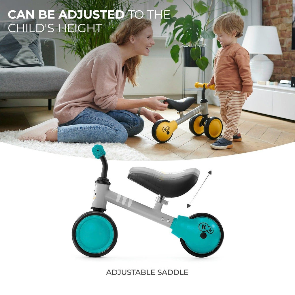 1. Child and parent with Kinderkraft CUTIE balance bike showing adjustable saddle feature