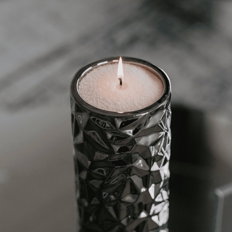 4. Close-up of Candledust Dark Honey powdered candle in a textured black holder