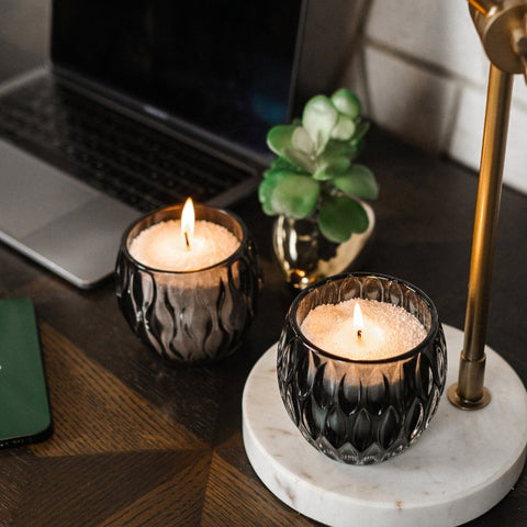 1. Two lit candles made from Candledust Powdered Candle Refill Kit - Midnight on a desk, creating a warm ambiance