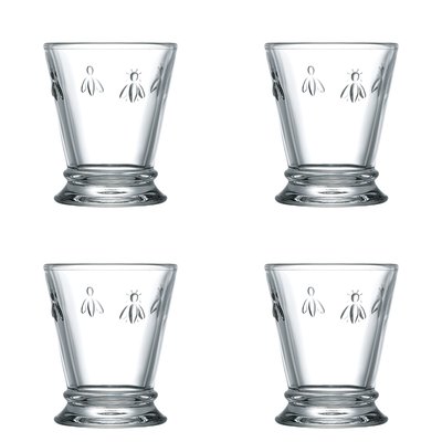 4. Flat lay of four transparent La Rochère Bee water glasses, each with embossed bee motif, on white background