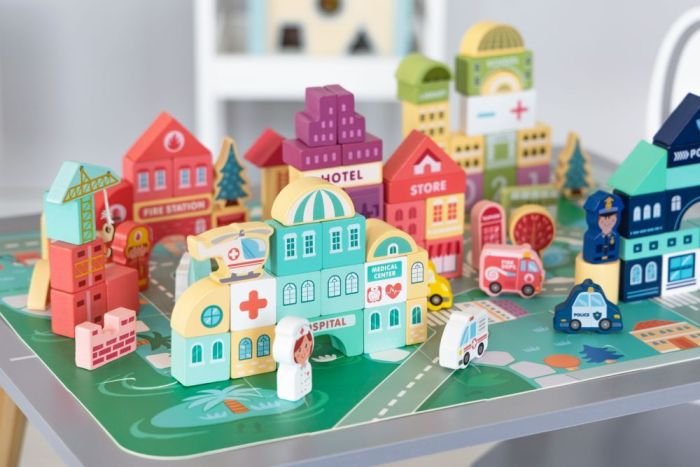 1. Colorful wooden cityscape with hospital, store, and police station on puzzle base, featuring vehicles and characters