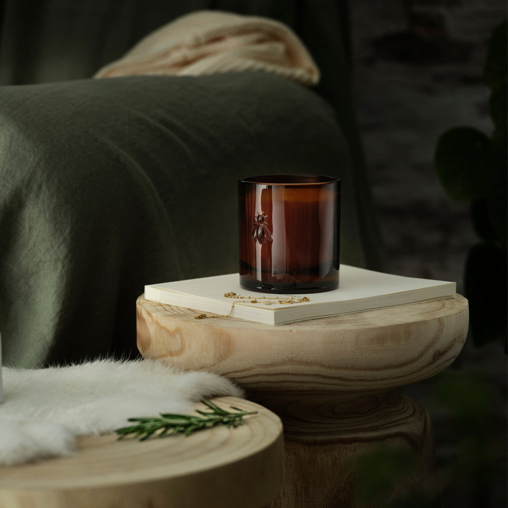 2. La Rochère Orange Blossom Bee Candle unlit, displayed on a wooden table in a cozy setting