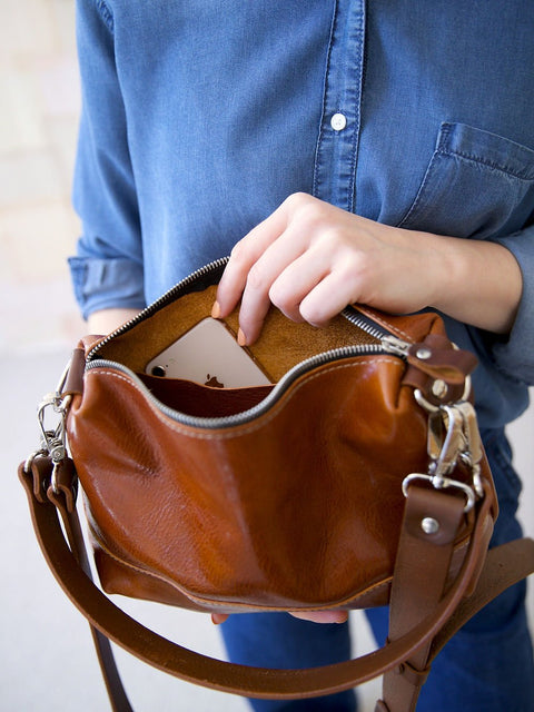 2. Close-up of TOKS VISOKS ROBIN leather handbag in ginger brown, showing interior with phone pocket