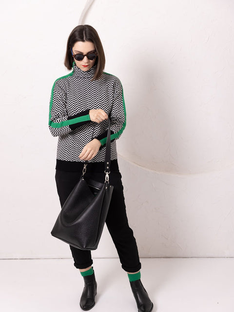 2. Woman wearing ADDISON Leather Tote in black, styled with patterned top and sunglasses