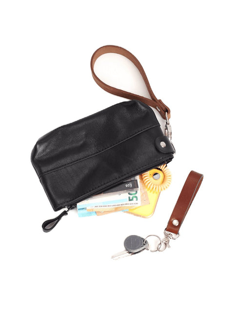 2. Black POUCH wallet by TOKS VISOKS with items inside, featuring removable brown wrist strap and secure zipper