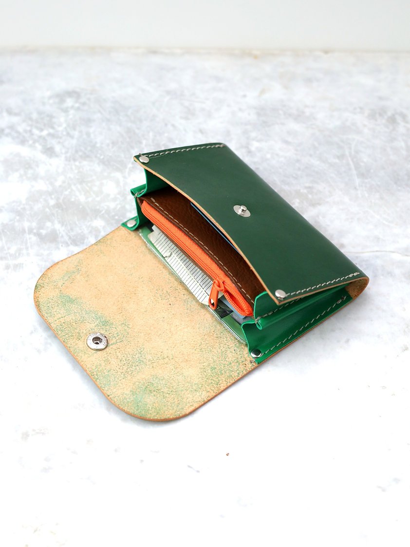 5. Top view of the open FRIDAY Wallet in green, featuring organized sections for cash and cards