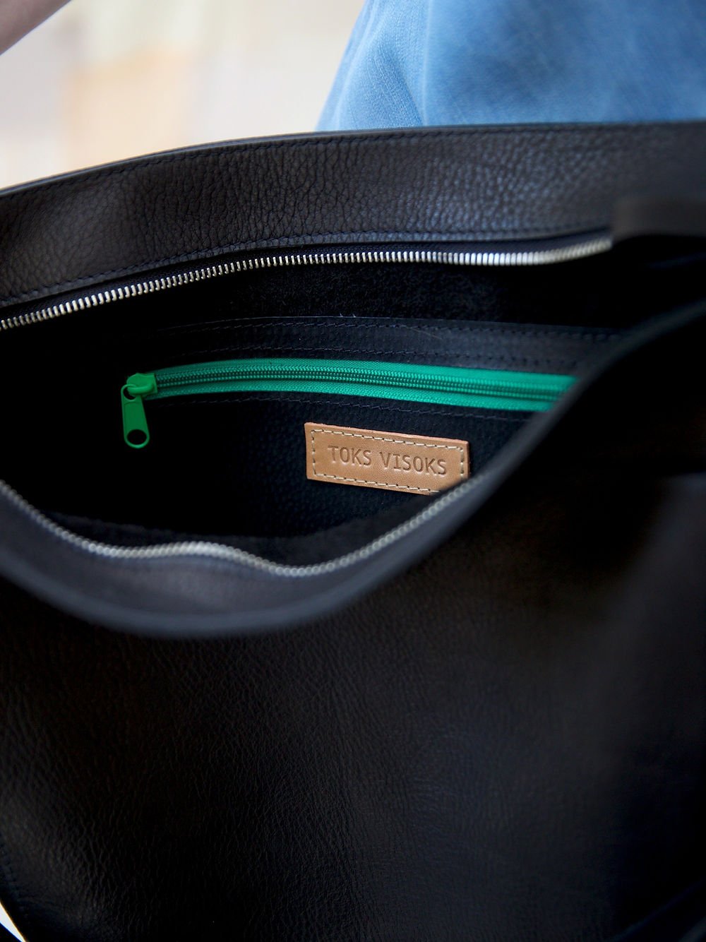 6. Interior view of LULU black handbag, showing TOKS VISOKS branding and zipper pocket