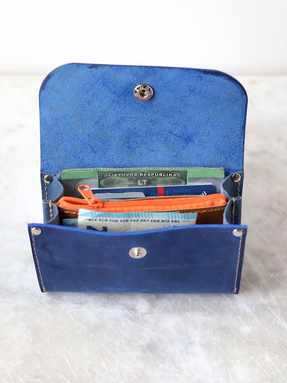 6. Open blue TOKS VISOKS FRIDAY Wallet, showcasing organized compartments for cards and cash