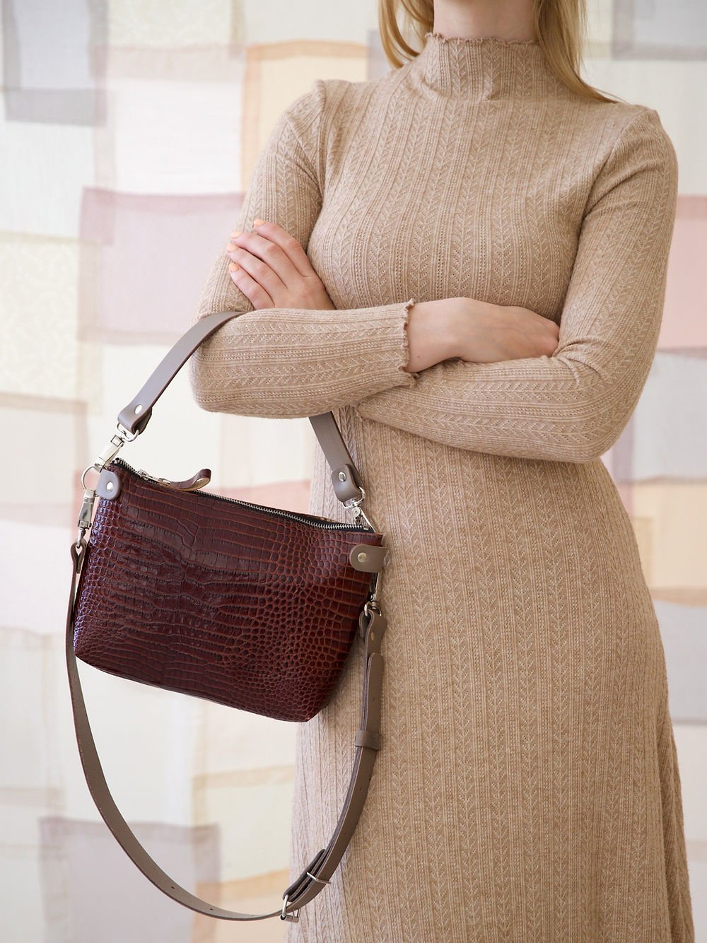 3. Women's TOMMY leather bag with crocodile pattern held by model, showing removable handles