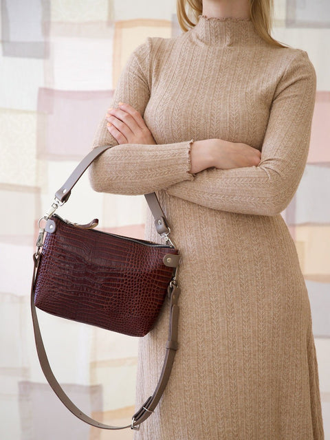 3. Women's TOMMY leather bag with crocodile pattern held by model, showing removable handles