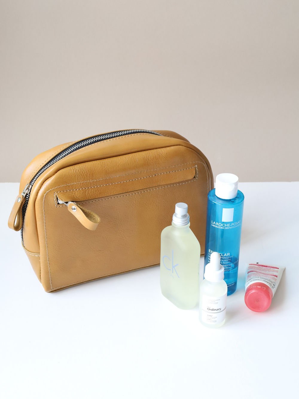 6. DOUGLAS Toiletry Bag in mustard with beauty products, showcasing spacious design, TOKS VISOKS brand