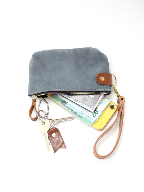 4. Close-up of TOKS VISOKS grey suede POUCH wallet with zipper open, showing interior with essentials