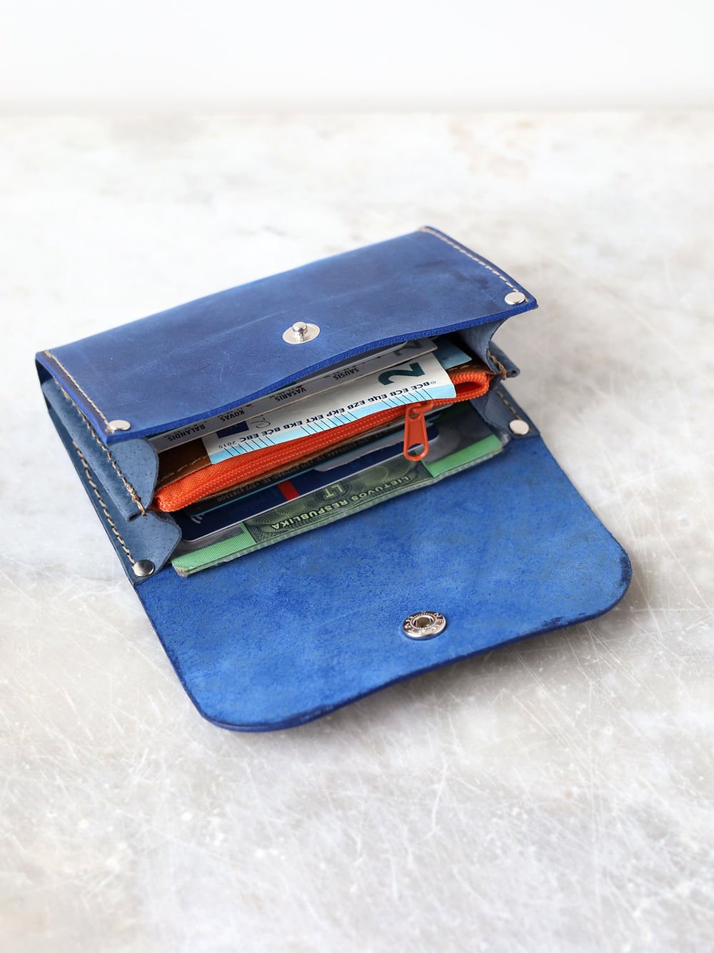 2. Open TOKS VISOKS FRIDAY Wallet in blue, displaying spacious interior with cards and cash