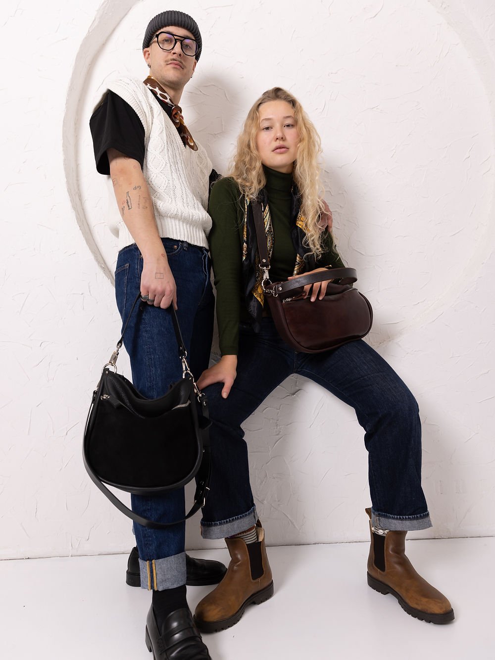 1. Woman wearing TOKS VISOKS STELLA leather handbag in brown and cognac, styled with a green top and scarf in lifestyle setting