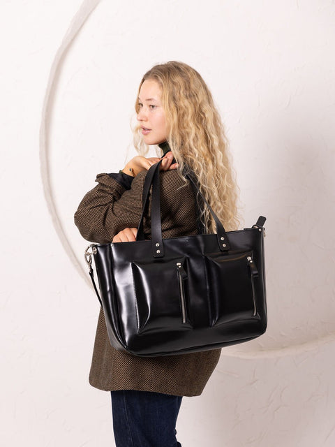 4. Women's black AMBER handbag by TOKS VISOKS, shown from the side in a studio setting