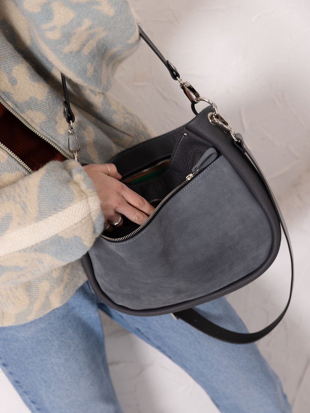 2. Close-up of TOKS VISOKS STELLA grey leather handbag with suede front pocket, showing interior organization