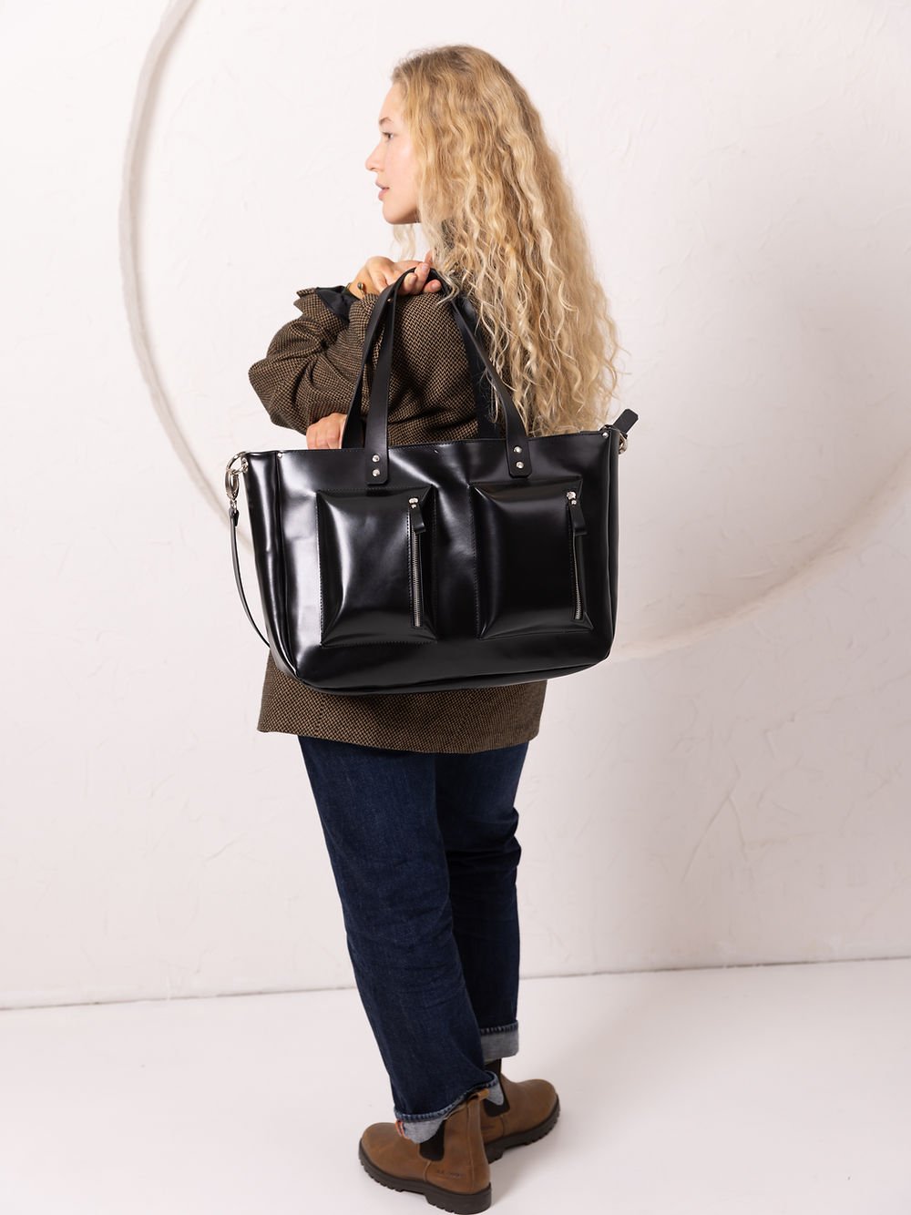 5. Women's black AMBER handbag by TOKS VISOKS, shown from the back in a studio setting