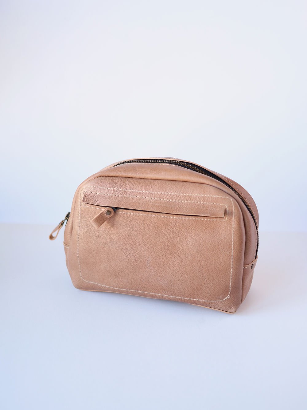 5. Studio shot of beige DOUGLAS Toiletry Bag by TOKS VISOKS, highlighting handmade leather craftsmanship