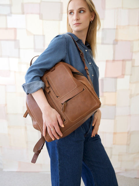 4. Woman holding TOKS VISOKS GORDON Backpack in Capuccino, lifestyle setting