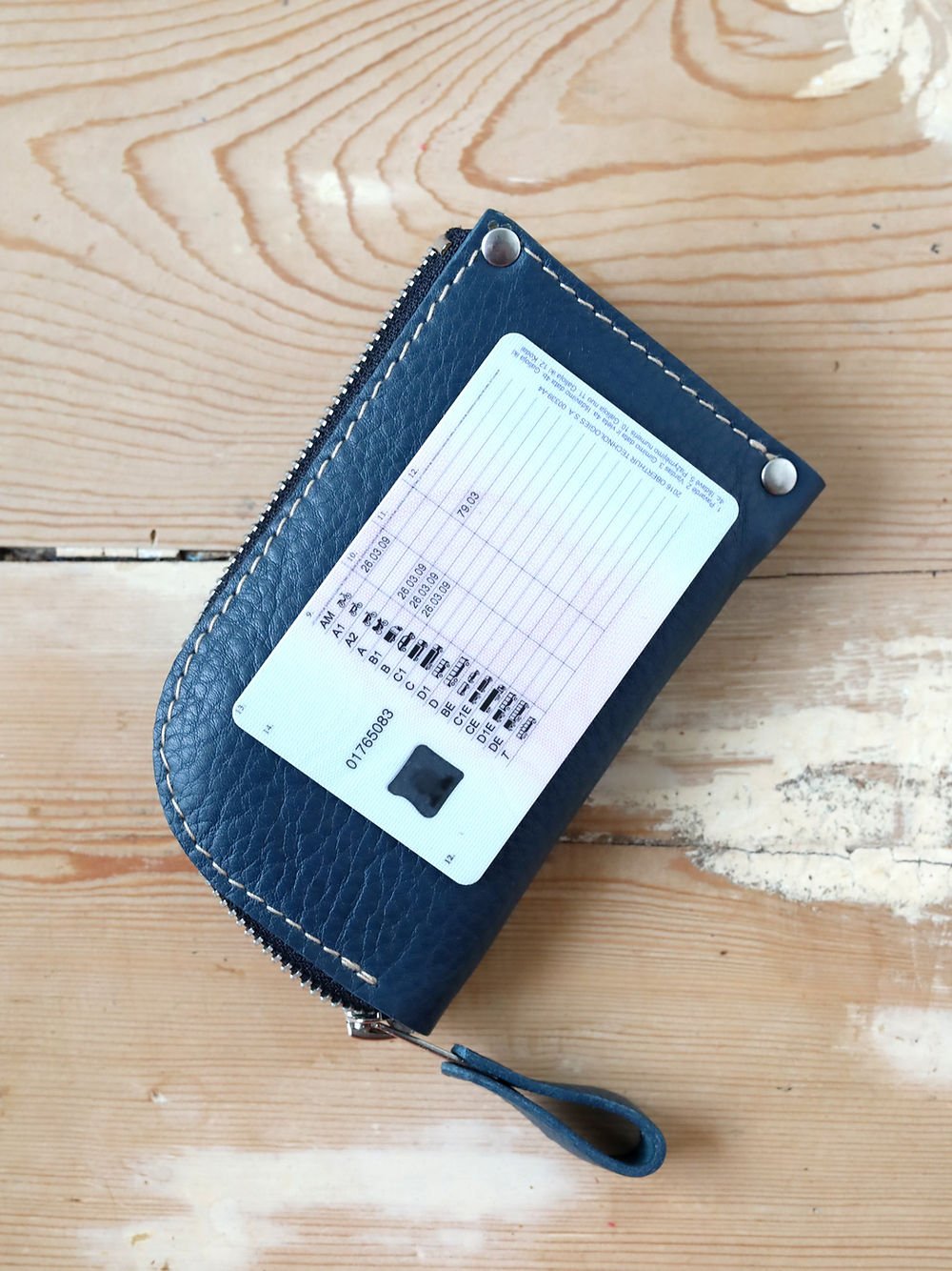 7. Blue WEDNESDAY Wallet by TOKS VISOKS with card inserted, showing card slot functionality