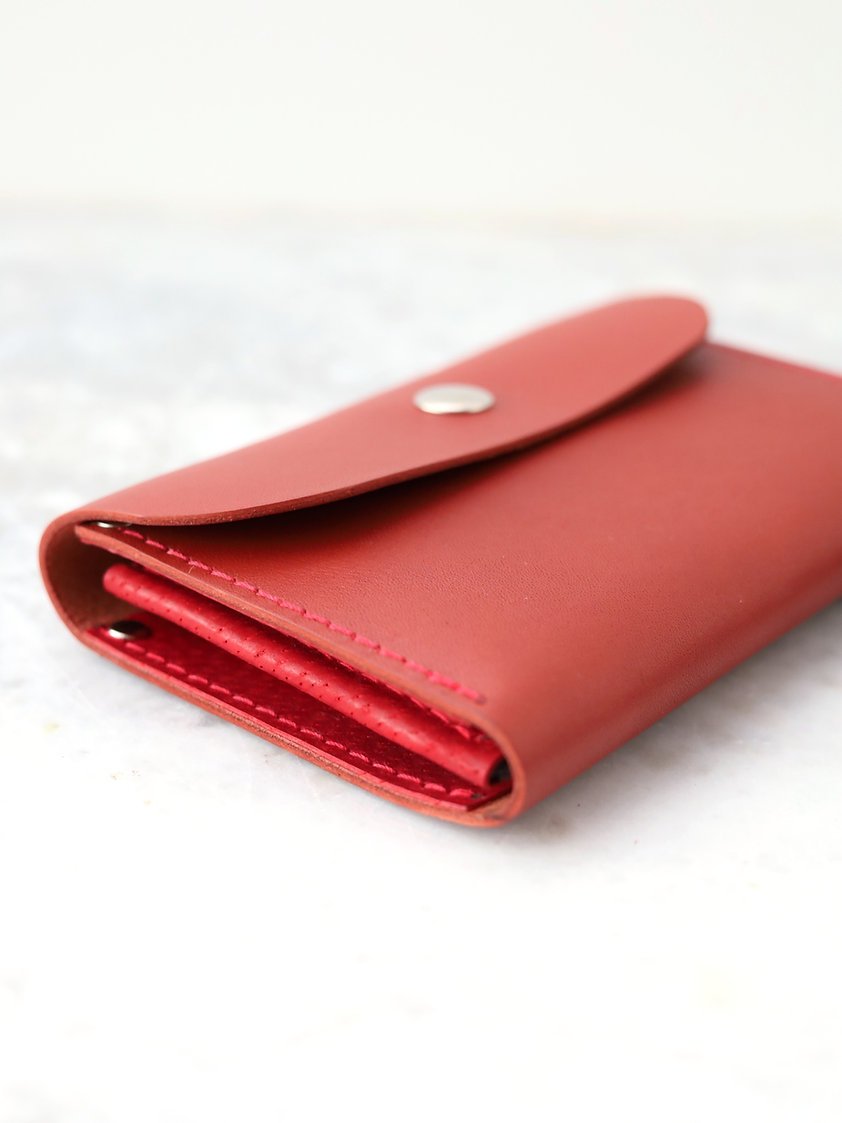 6. Close-up of TOKS VISOKS FRIDAY Wallet in faded red, focusing on stitching and material