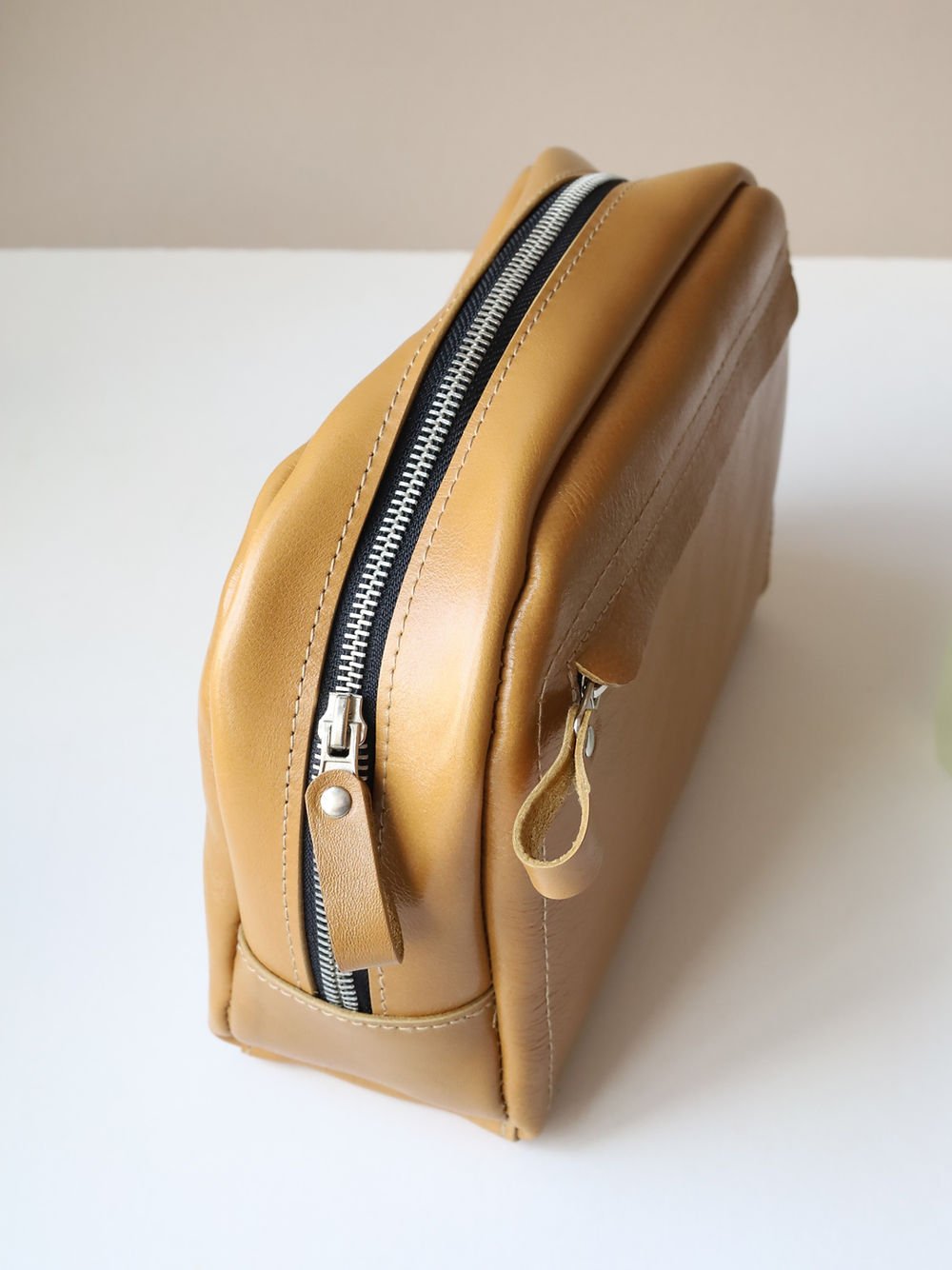 3. Side view of DOUGLAS Toiletry Bag in mustard with smooth running zipper, TOKS VISOKS brand