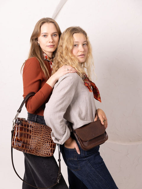 1. Women's brown marble RUBY Purse by TOKS VISOKS, worn crossbody by two models in a studio setting