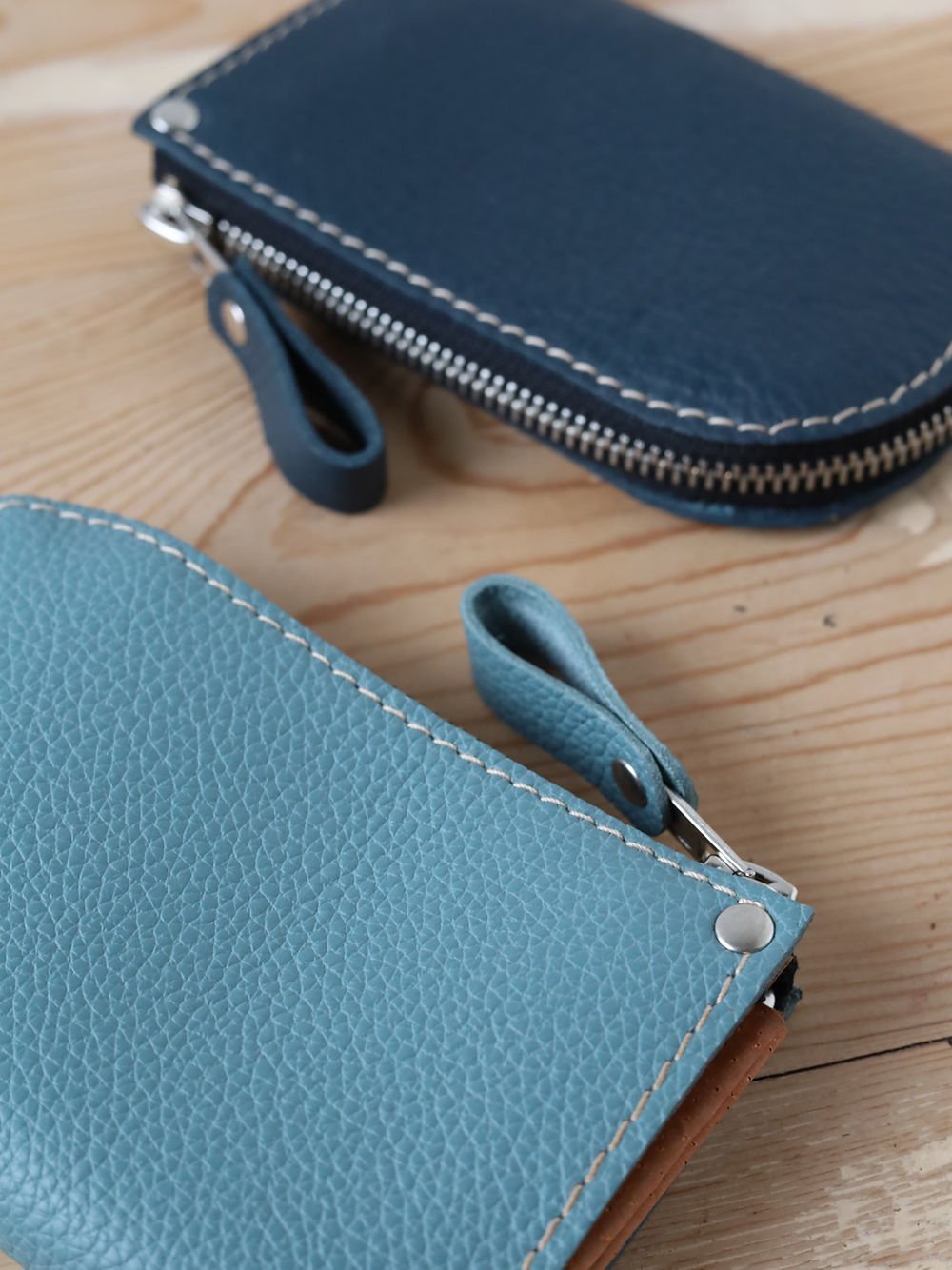 6. Close-up of blue and light blue WEDNESDAY Wallets by TOKS VISOKS showing texture and zipper