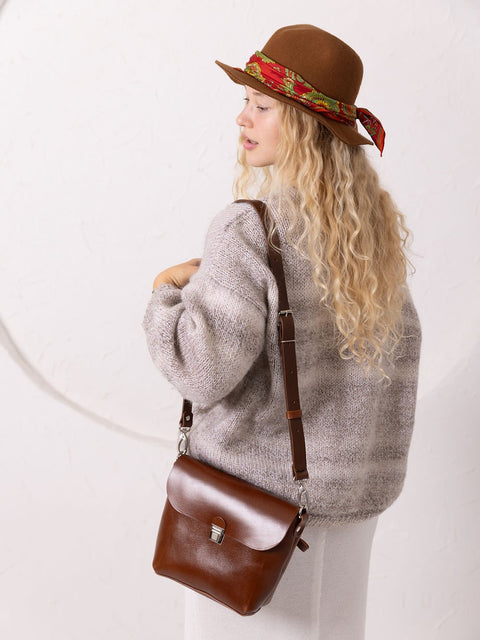 5. Woman with TOKS VISOKS ARLO Purse in ginger, shown from the back with adjustable strap