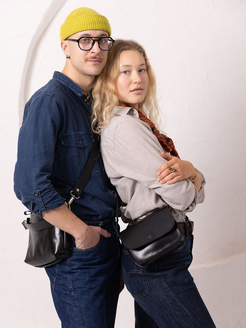 5. Unisex black RUBY Purse by TOKS VISOKS worn by male and female models in studio
