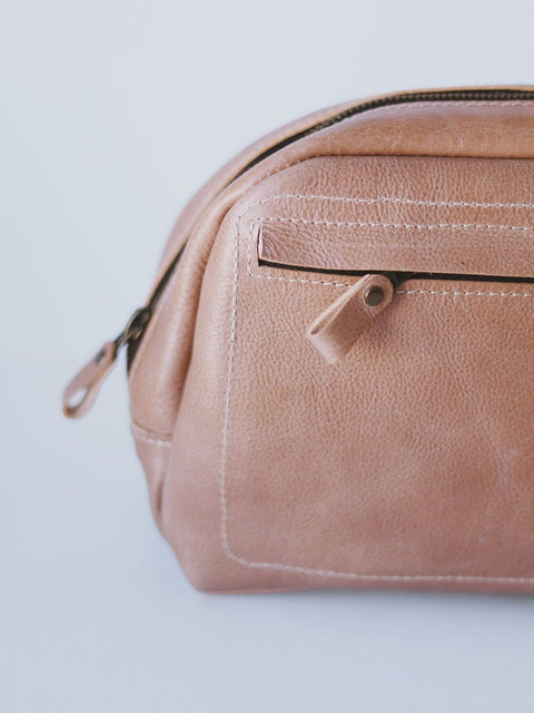 4. Close-up of beige DOUGLAS Toiletry Bag by TOKS VISOKS, showing front zipped pocket and leather texture