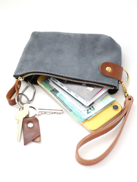 2. Grey suede POUCH wallet by TOKS VISOKS with keys, phone, and cash inside, highlighting multi-purpose use