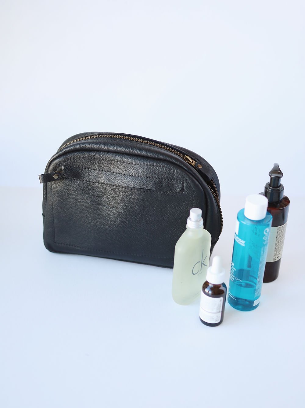 3. TOKS VISOKS black toiletry bag with various bottles, showcasing storage capacity