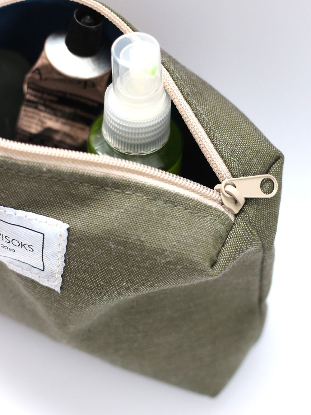 1. Close-up of TOKS VISOKS LORNA Makeup Bag in army green, showing spacious interior with toiletries