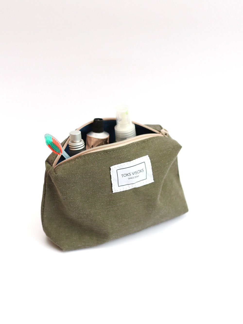 5. Side view of TOKS VISOKS LORNA Makeup Bag in army green, displaying spacious design