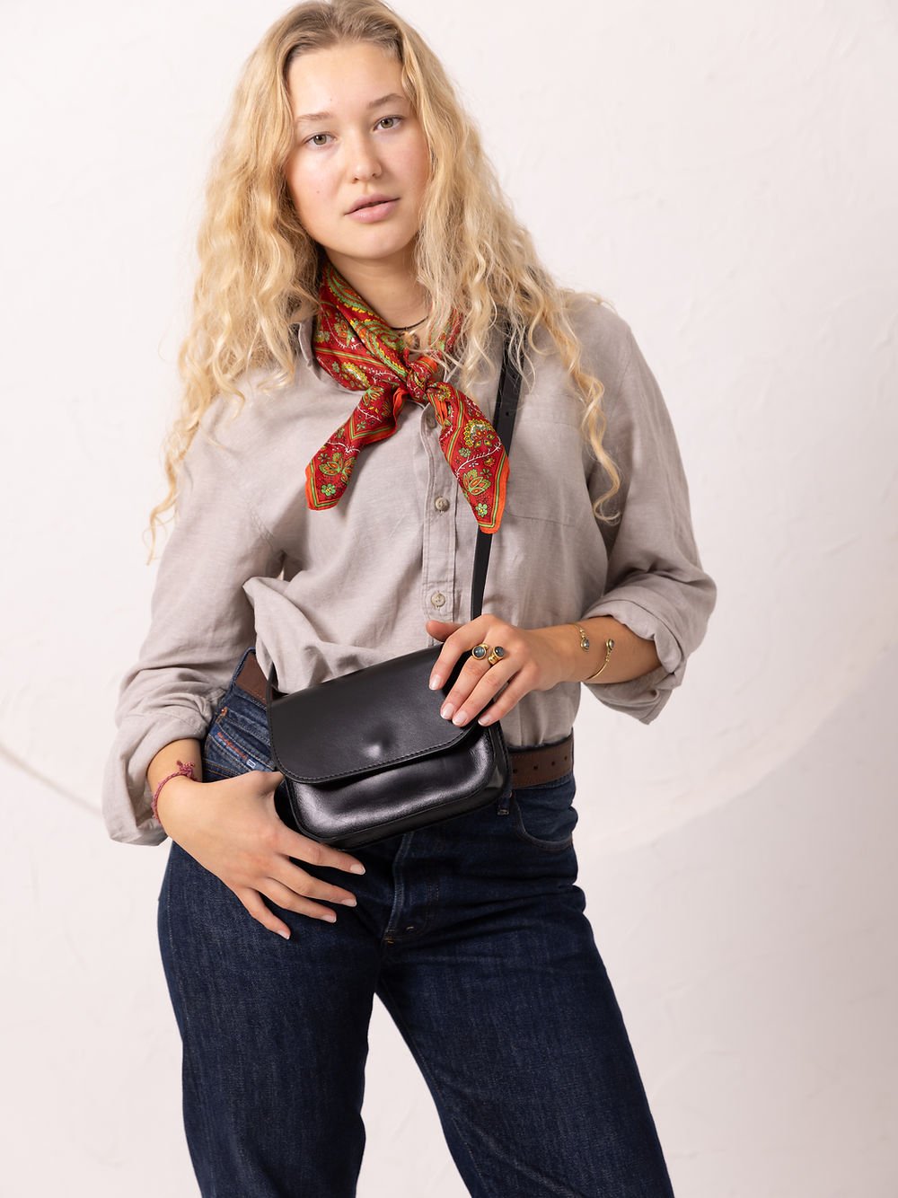 7. Women's black RUBY Purse by TOKS VISOKS worn crossbody, shown in studio
