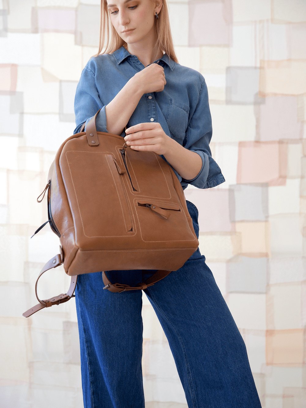 5. Woman adjusting TOKS VISOKS GORDON Backpack in Capuccino, lifestyle setting